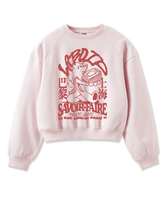 Sweat rose clair en coton avec imprimé rouge, coupe classique avec manches raglan et bord-côte aux poignets et à la taille, pour un style décontracté et féminin.