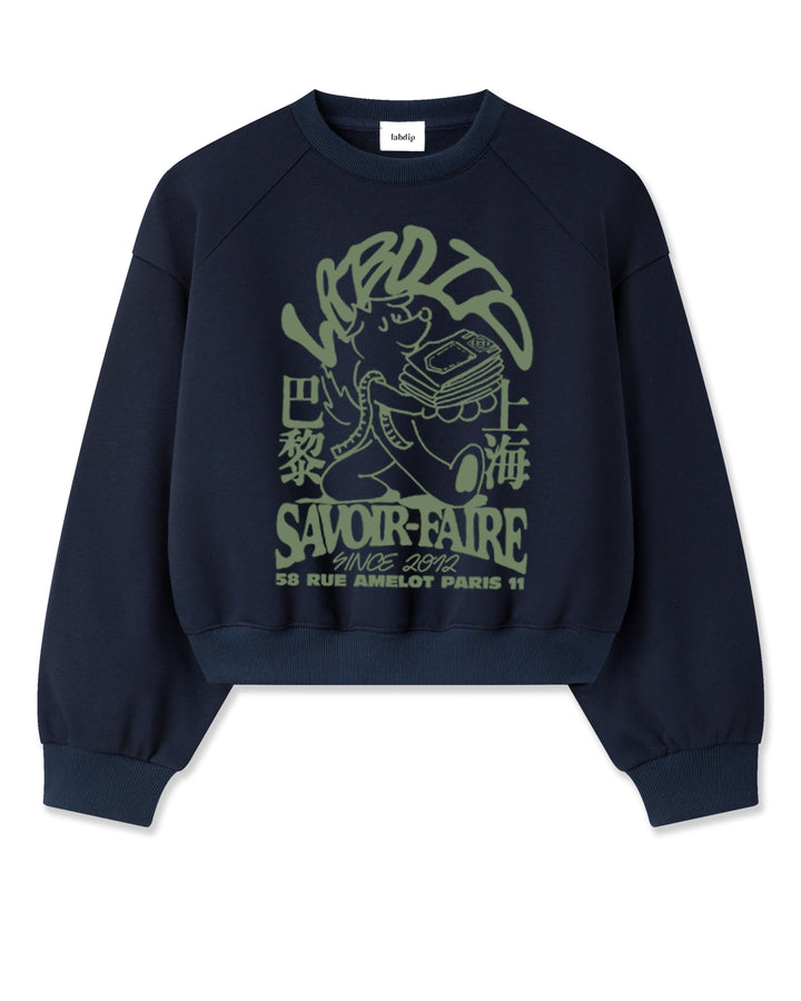 Sweat en coton navy avec imprimé graphique vert, coupe droite et manches raglan pour un style décontracté et confortable au quotidien.