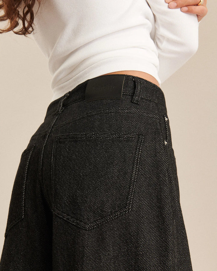 Jean pour femme en denim foncé gris anthracite, coupe large et fluide, matière 100 % coton avec texture 3D offrant un tombé léger et confortable.