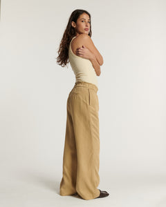 Pantalon large en tencel beige clair avec taille élastique, coupe fluide et confortable, idéal pour un look décontracté et élégant au quotidien.
