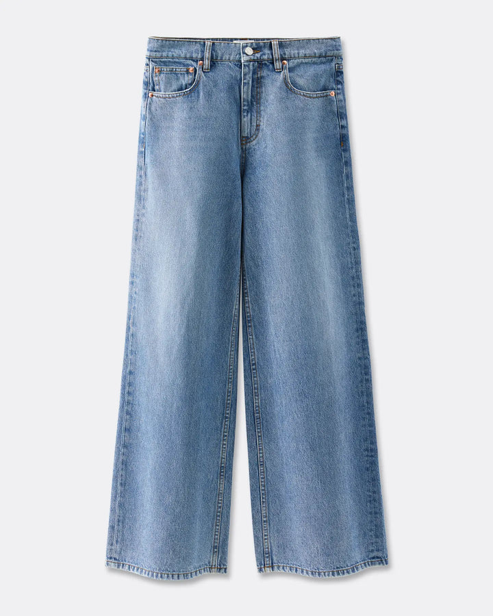 Jean large en denim bleu clair avec une coupe droite et une matière 100% coton, offrant un tombé fluide et confortable adapté à toutes les morphologies.